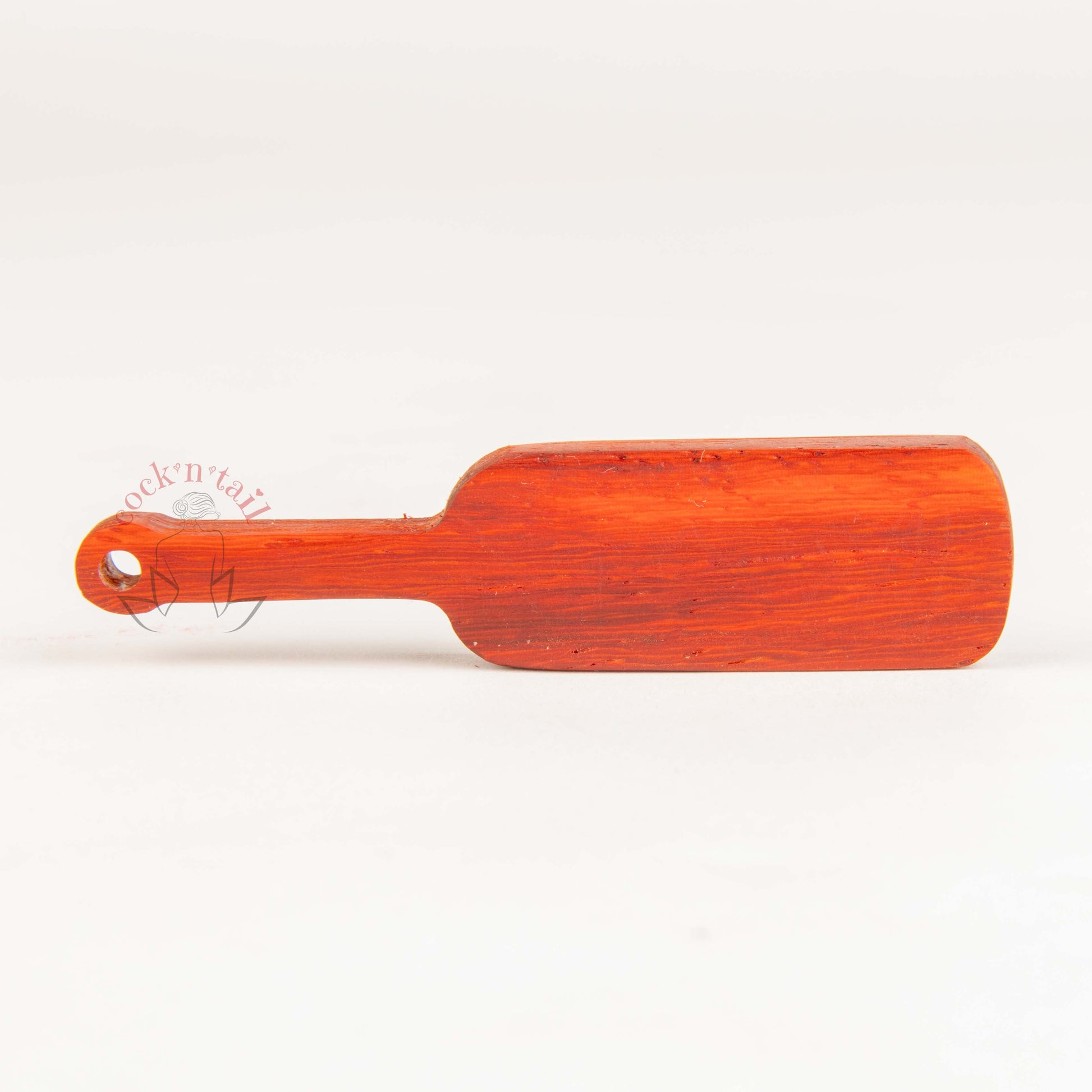 Paddle shaped keychain with the word "SLUT" engraved